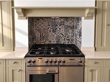 A kitchen with a stove and patterned backsplash at Rheidiol St Davids