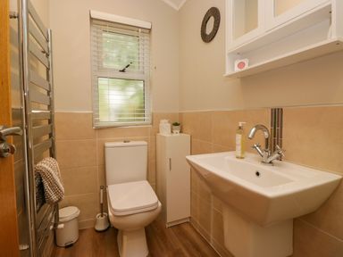 A bathroom featuring a sink and toilet at Fir Tree Lodge, White Cross bay on Windermere, Troutbeck Bridge