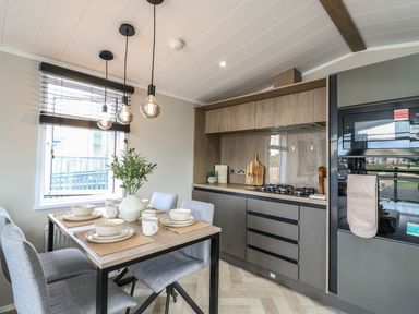 A kitchen with dining table and chairs at Lakewood Plot 7 Clacton-on-Sea