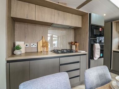A kitchen with cabinets and appliances at Lakewood Plot 7 Clacton-on-Sea