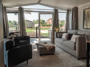 A living room with a sofa and armchairs at Lakewood Plot 7 in St. Osyth