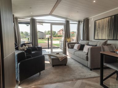 A living room with sofa and armchairs at Lakewood Plot 7 in St. Osyth