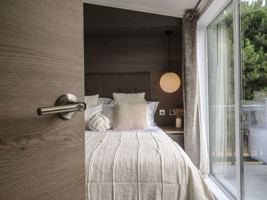 A bedroom with a bed and a window at Lakewood Plot 9 in Clacton-on-Sea