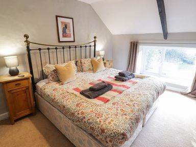 A bedroom with a bed and bedside table at Ty'r Wennol Fishguard