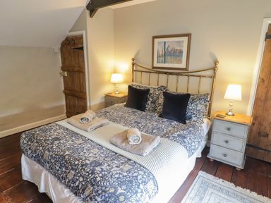 A bedroom with a bed and nightstand at Ty'r Wennol in Fishguard