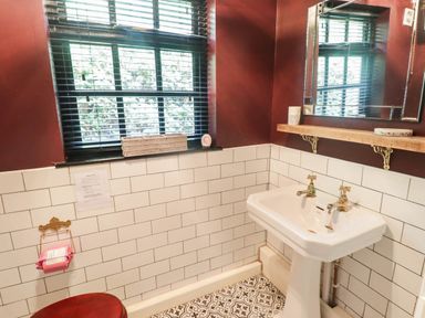 A bathroom with a sink and mirror at Ty'r Wennol in Fishguard