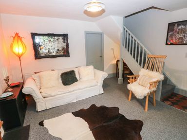 A living room with a sofa and rocking chair at 11 Church Street Narberth