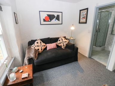 A living room with a sofa and side table at 11 Church Street Narberth