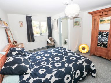 A bedroom with a bed and wardrobe at 11 Church Street in Narberth