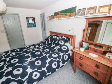 A bedroom with a bed and nightstand at 11 Church Street in Narberth
