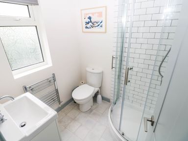 A bathroom with a shower, toilet, and sink at 11 Church Street, Narberth