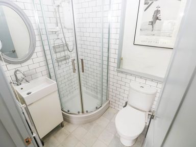 A bathroom with a shower, toilet, and sink at 11 Church Street Narberth