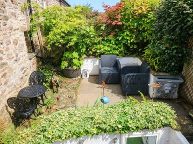 A garden with seating area and plants at 11 Church Street in Narberth