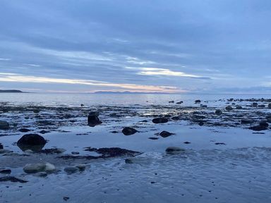 A beach with rocks and water at Beautifully Presented 2 Bedroom Static Caravan Monreith near Whithorn