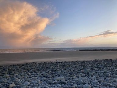 A beach with rocks and ocean at Beautifully Presented 2 Bedroom Static Caravan in Monreith near Whithorn