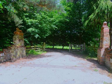 An outdoor entrance with brick gate posts and a pathway at Elm Farm