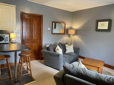 A living room with a sofa and coffee table at Milecastle Inn on Hadrian's Wall near Haltwhistle