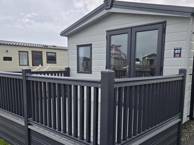 A cabin exterior with a deck at 3 Bedroom Cabin Sleeps 6 - Shared Pool & Shared Hot Tub, Flamingo Land Resort near Malton