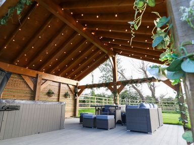 An outdoor area with seating and a hot tub at Northumberland Luxury Stays - The Chivits near West Chevington