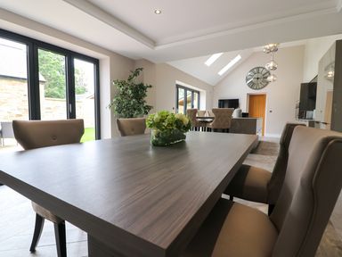 A dining room with a table and chairs at Northumberland Luxury Stays - The Chivits near Amble
