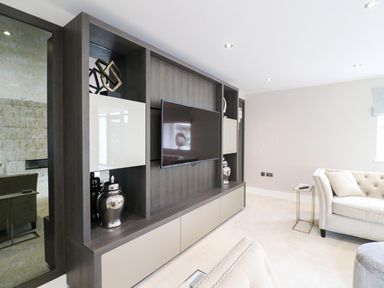 A living room with a television and decorative objects at Northumberland Luxury Stays - The Chivits near Amble