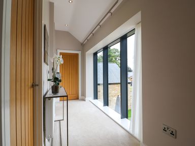 A hallway with a door and window at Northumberland Luxury Stays - The Chivits near Amble