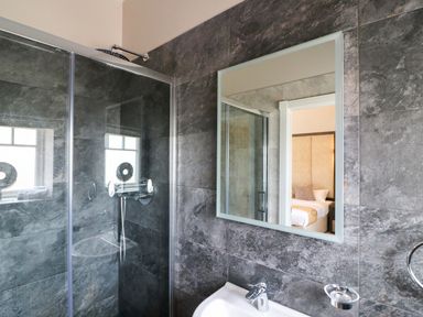 A bathroom with a shower and mirror at Northumberland Luxury Stays - The Chivits near Amble