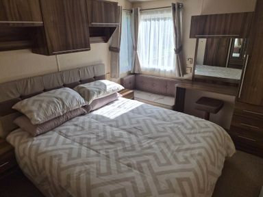 A bedroom with a bed, mirror, and couch at Cabin - Sleeps 6 - Outdoor Pool and Parking, Cenarth