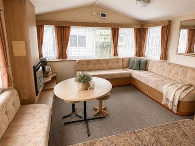 A living room with a sofa and table at Seaside Tranquility Retreat in Clacton