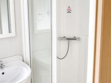 A bathroom with a shower and a sink at Seaside Tranquility Retreat in Clacton