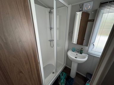 A bathroom with shower and sink at Wl34 Caravan Haggerston Castle Private Decking Haggerston