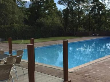 An outdoor area with a swimming pool and seating at Pet Friendly 2-Bed Lodge, Sleeps 5, Pool & Parking in Caernarfon