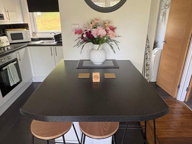 A kitchen with a counter and flower vase at Pet Friendly 2-Bed Lodge, Sleeps 5, Pool & Parking, Caernarfon