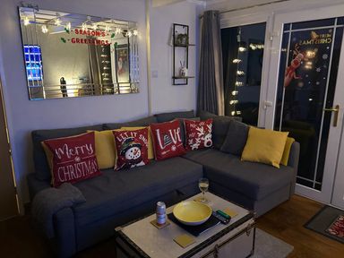 A living room with a sofa and decorative items at Pet Friendly 2-Bed Lodge, Sleeps 5, Pool & Parking, Caernarfon