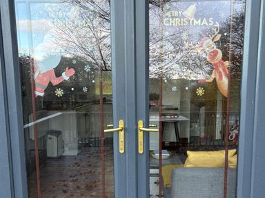 A door with Christmas decorations featuring Santa Claus and Rudolph at Pet Friendly 2-Bed Lodge, Sleeps 5, Pool & Parking, Caernarfon