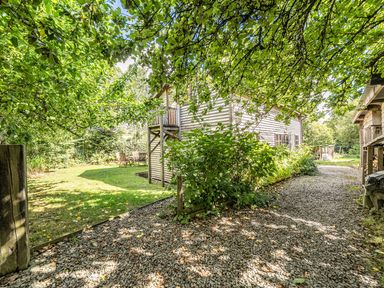 A garden with a gravel path and outdoor seating at 3-Bed Barn Eco-Lodge on the Tarka trail, East Yarde near Great Torrington
