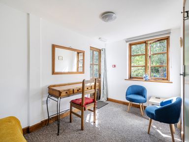 A room with a table and chairs at 3-Bed Barn Eco-Lodge on the Tarka trail, East Yarde near Great Torrington