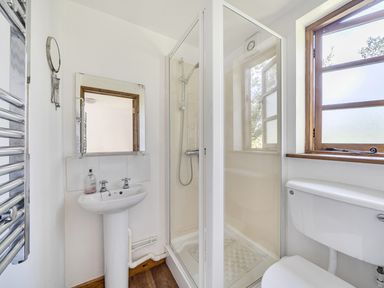 A bathroom with a shower, sink, and toilet at 3-Bed Barn Eco-Lodge on the Tarka trail East Yarde near Great Torrington