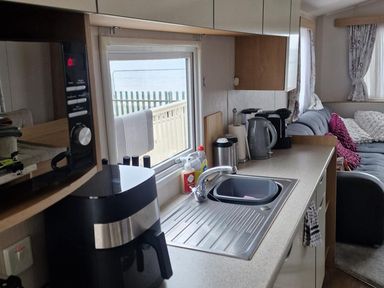 A kitchen with a sink and appliances at Seafront Caravan - Golden Sands - 6 Berth by Your Away Stays Kinmel Bay