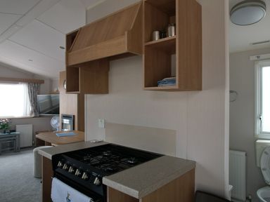 A kitchen with stove and kitchen cabinet at Seafront Caravan - Golden Sands - 6 Berth by Your Away Stays in Kinmel Bay