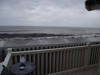A view of the sea and rocks from a deck at Seafront Caravan - Golden Sands - 6 Berth by Your Away Stays in Kinmel Bay