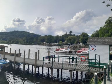 A dock with boats and pier at Pier 2 near a lake