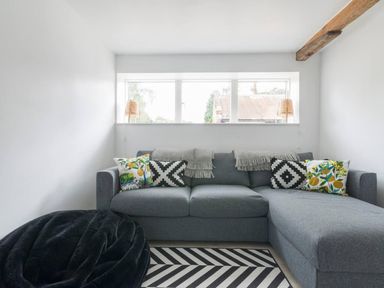 A snug area with a sofa and pillows at Simple Coastal Luxury near Southwold sleeps 10 near Southwold