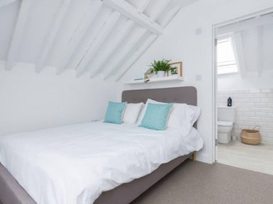 A bedroom with a bed and shelf at Simple Coastal Luxury near Southwold sleeps 10 near Southwold