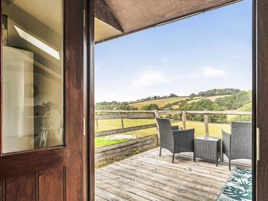 A deck with seating and a view at The Shippon, Breathtaking Views, Private Hot Tub in Winkleigh