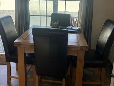 A dining room with a table and chairs at Chalet Sleeps 4 Near Cymyran Beach Caergeiliog
