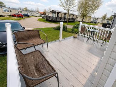 An outdoor area with seating and a table at Tattershall Lakes - Hot Tub - Sleeps 6 - Pets, Tattershall