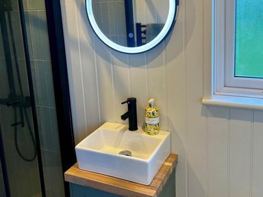 A bathroom with a sink and mirror at Peaceful Shepherd Hut near Clovelly Buckland Brewer near Great Torrington