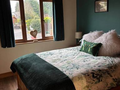 A bedroom with a bed and window at Cabin Sleeps 4 with Hot Tub and Parking near Wilberfoss