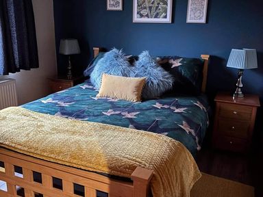 A bedroom with a bed and lamps at Cabin Sleeps 4 with Hot Tub and Parking near Wilberfoss